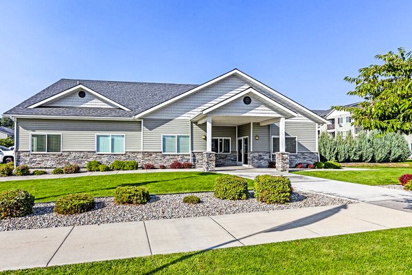 Trillium Apartments: Elegant entrance with lush landscaping in downtown setting