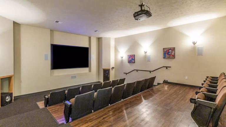 Clubhouse theater featuring plush seating and large screen at Trillium Apartments