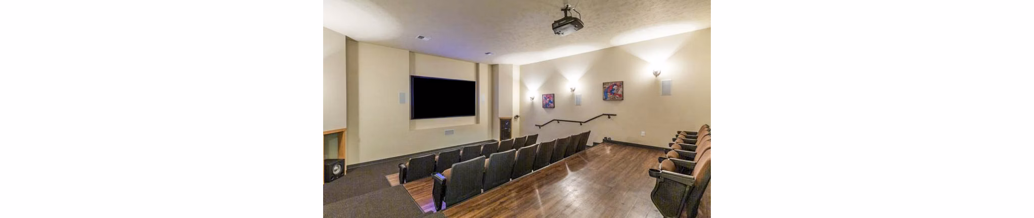 Clubhouse theater featuring plush seating and large screen at Trillium Apartments