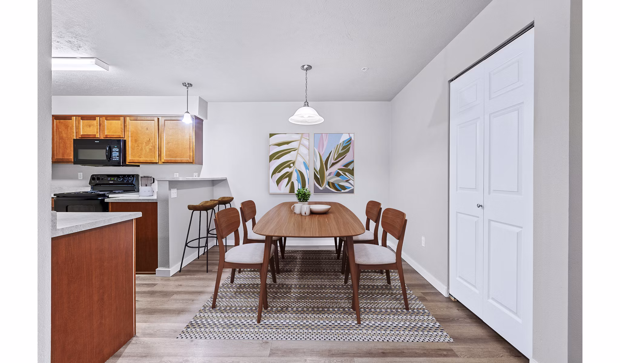 Dining room featuring elegant tableware and modern lighting at Trillium Apartments