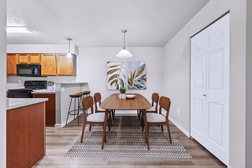 Dining room featuring elegant tableware and modern lighting at Trillium Apartments