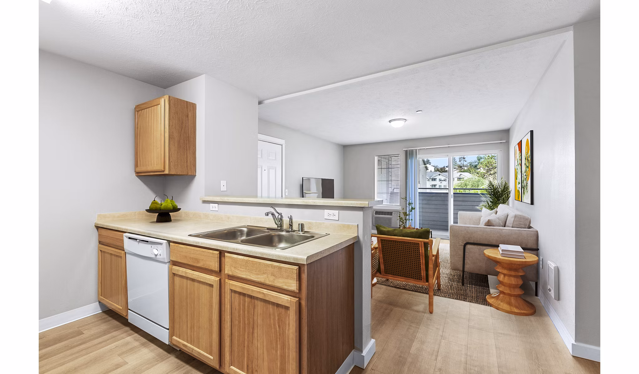 Modern kitchen featuring stainless steel appliances and quartz countertops in Trillium Apartments