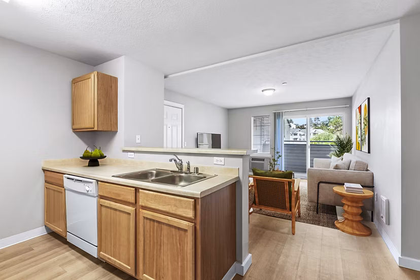 Modern kitchen featuring stainless steel appliances and quartz countertops in Trillium Apartments