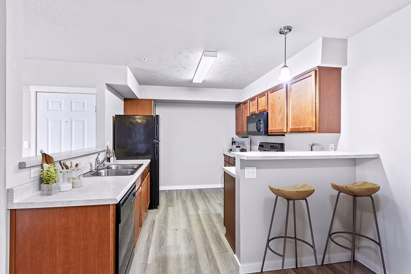 Modern kitchen with stainless steel appliances in Trillium Apartments