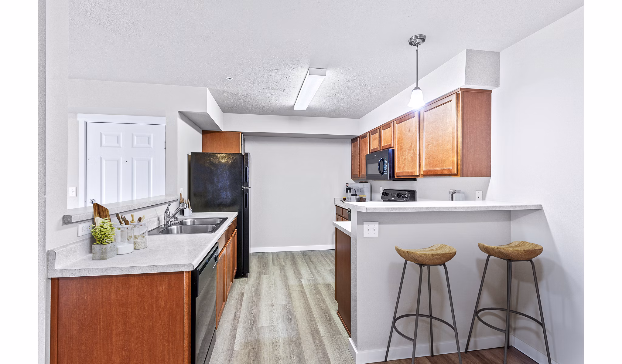 Modern kitchen with stainless steel appliances in Trillium Apartments