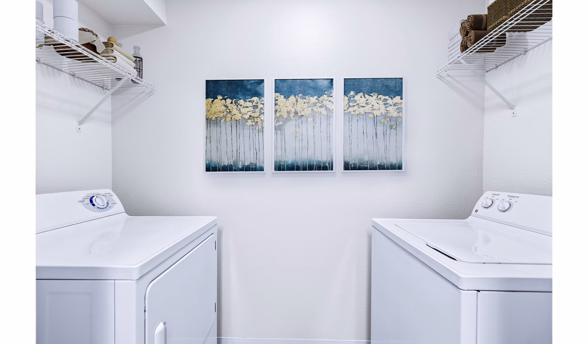 Laundry room equipped with modern washers and dryers in Trillium Apartments luxury community