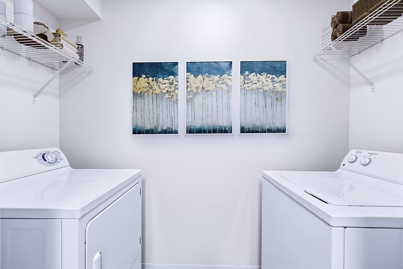 Laundry room equipped with modern washers and dryers in Trillium Apartments luxury community