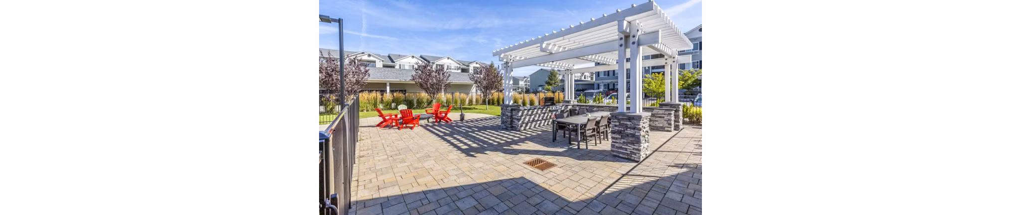Spacious outdoor grill area and patio at Trillium Apartments, perfect for entertaining and relaxation