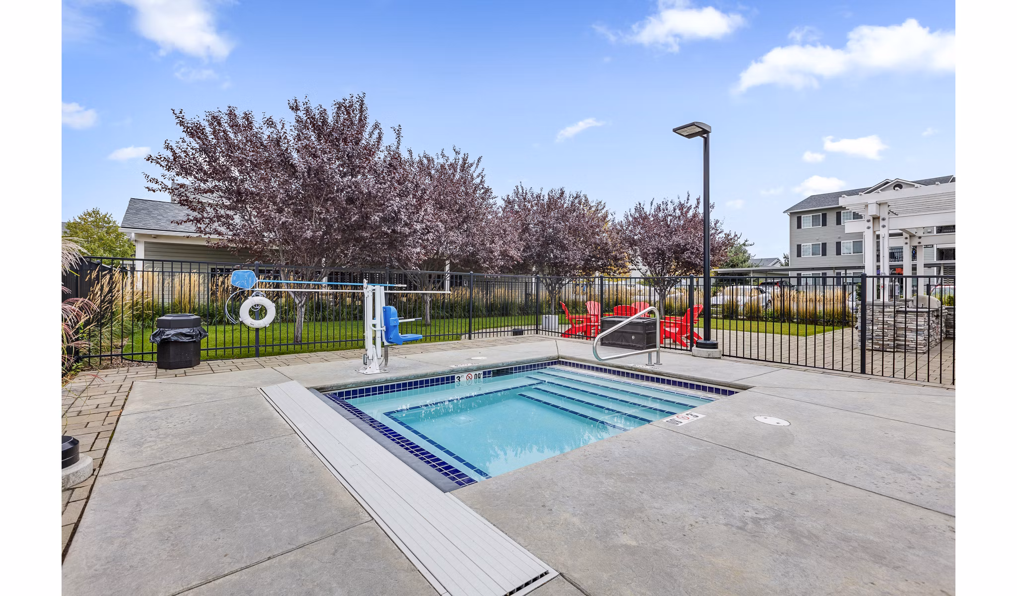 Resort-style pool with wood deck at Trillium Apartments, offering luxury amenities for relaxation
