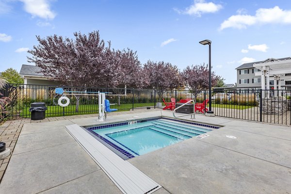 Resort-style pool with wood deck at Trillium Apartments, offering luxury amenities for relaxation