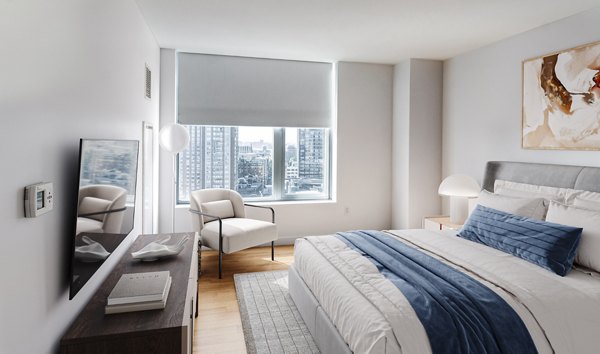 Elegant bedroom featuring modern decor and large windows in Radian Apartments A luxury experience in urban living