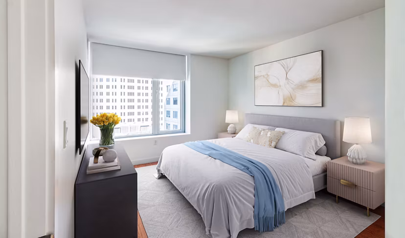 Modern bedroom with large windows and stylish decor at Radian Apartments, offering luxury living in a prime location