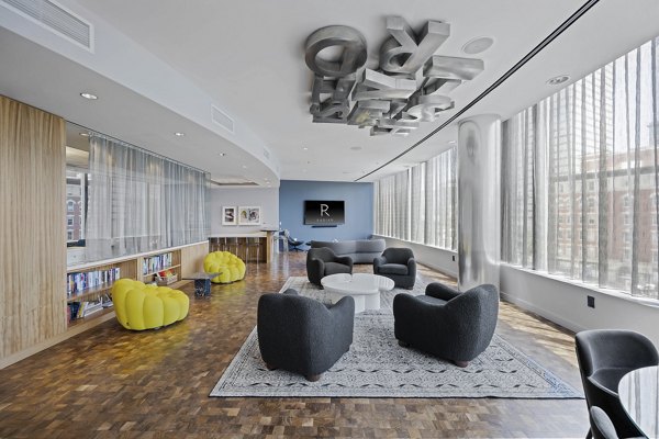 Elegant clubhouse with modern design at Radian Apartments, offering a luxurious space for residents to gather and socialize