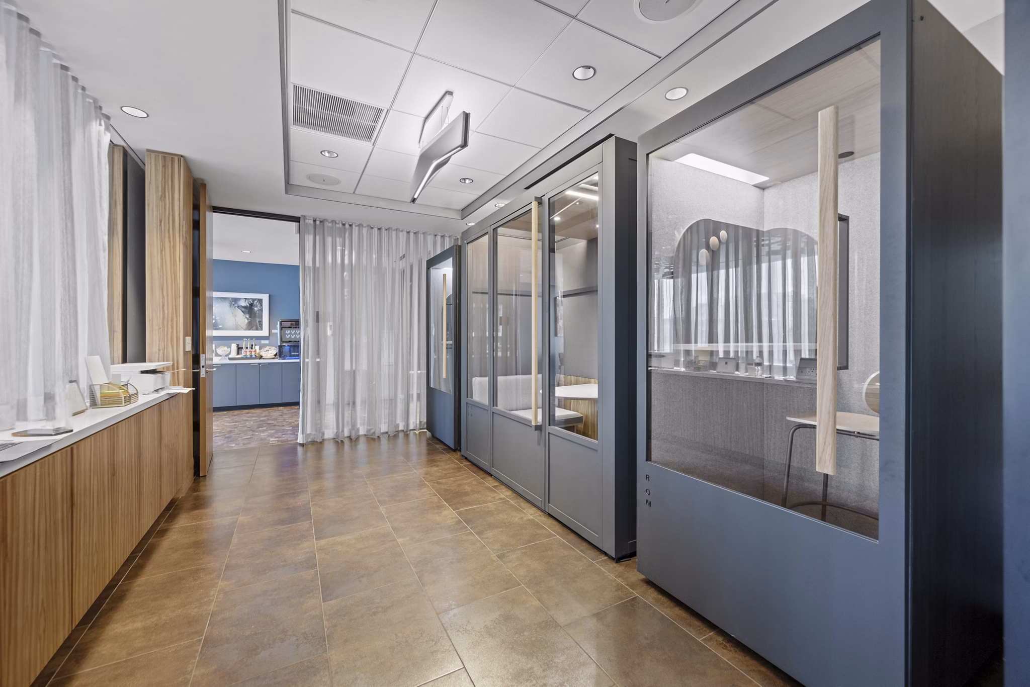 Home office with modern desk setup at Radian Apartments featuring ample natural light and stylish decor