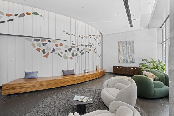 Modern lobby featuring elegant seating and ambient lighting at Radian Apartments, luxury living by Greystar in the heart of the city