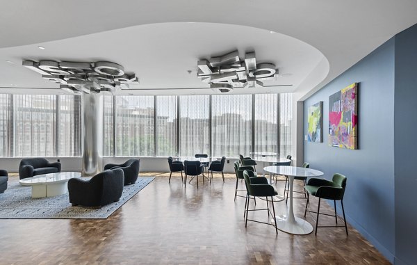 Modern dining room with elegant lighting and stylish furnishings at Radian Apartments in vibrant urban setting