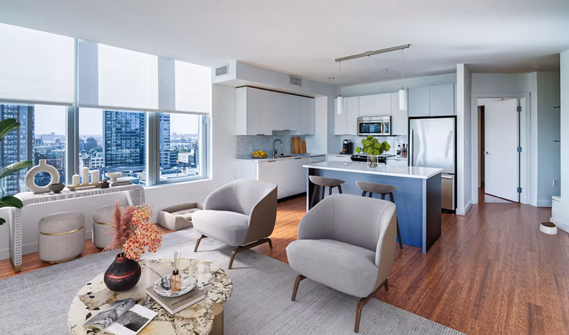 Spacious living room with modern furnishings and large windows in Radian Apartments, offering a luxurious lifestyle experience