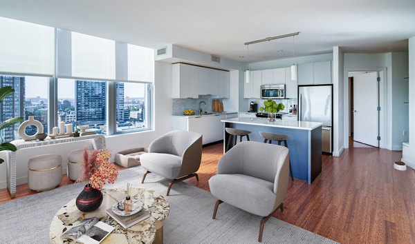Spacious living room with modern furnishings and large windows in Radian Apartments, offering a luxurious lifestyle experience