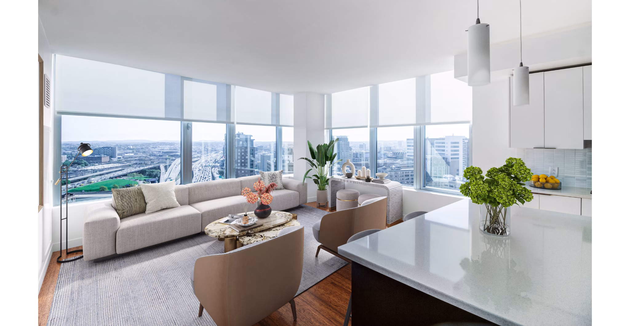 Bright living room with cozy seating and city views in Radian Apartments, luxury living in the heart of the city