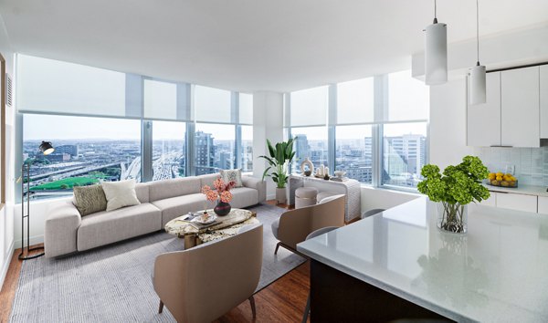 Bright living room with cozy seating and city views in Radian Apartments, luxury living in the heart of the city