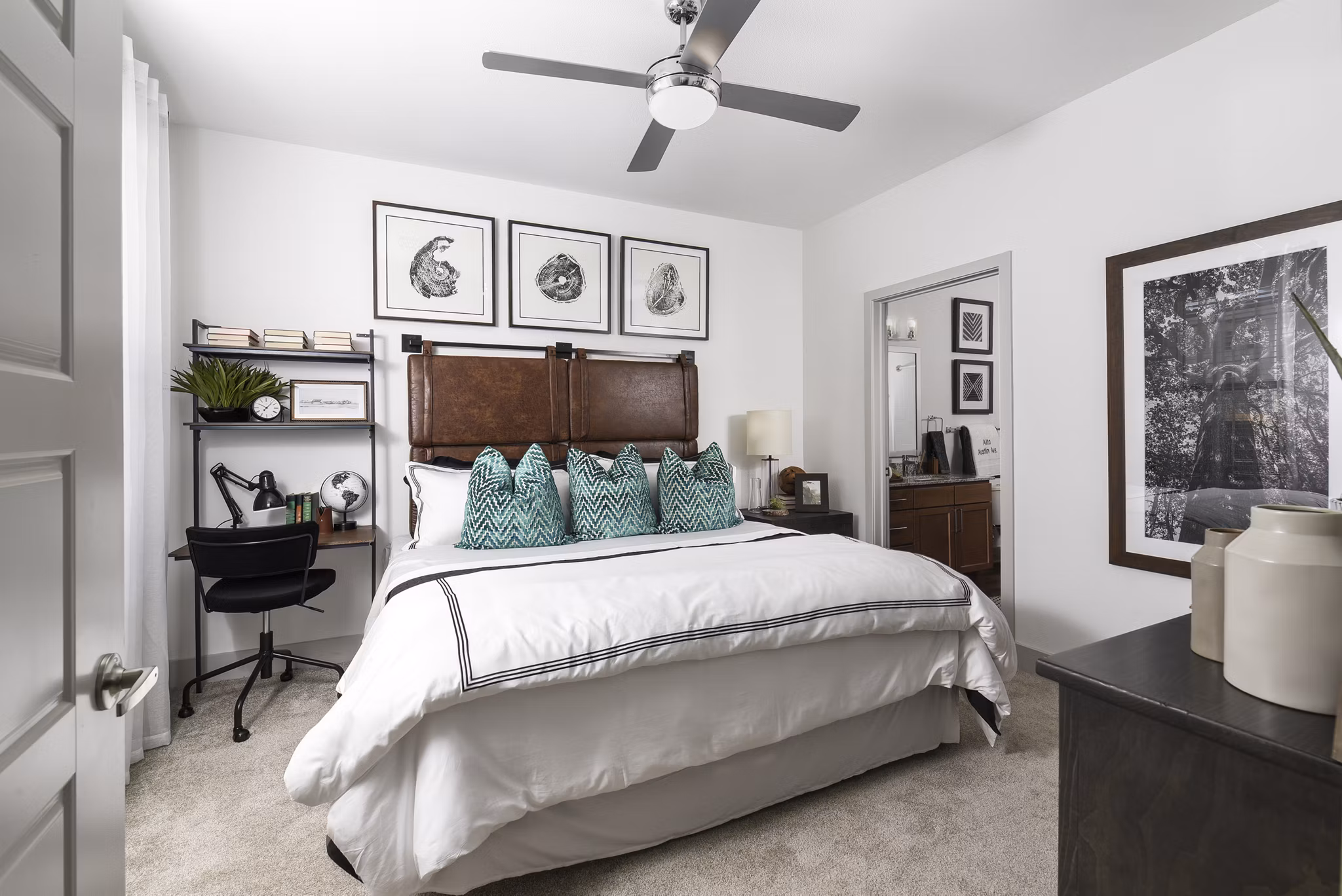 Cozy bedroom with modern decor and ample natural light at Austin Avenue Apartments