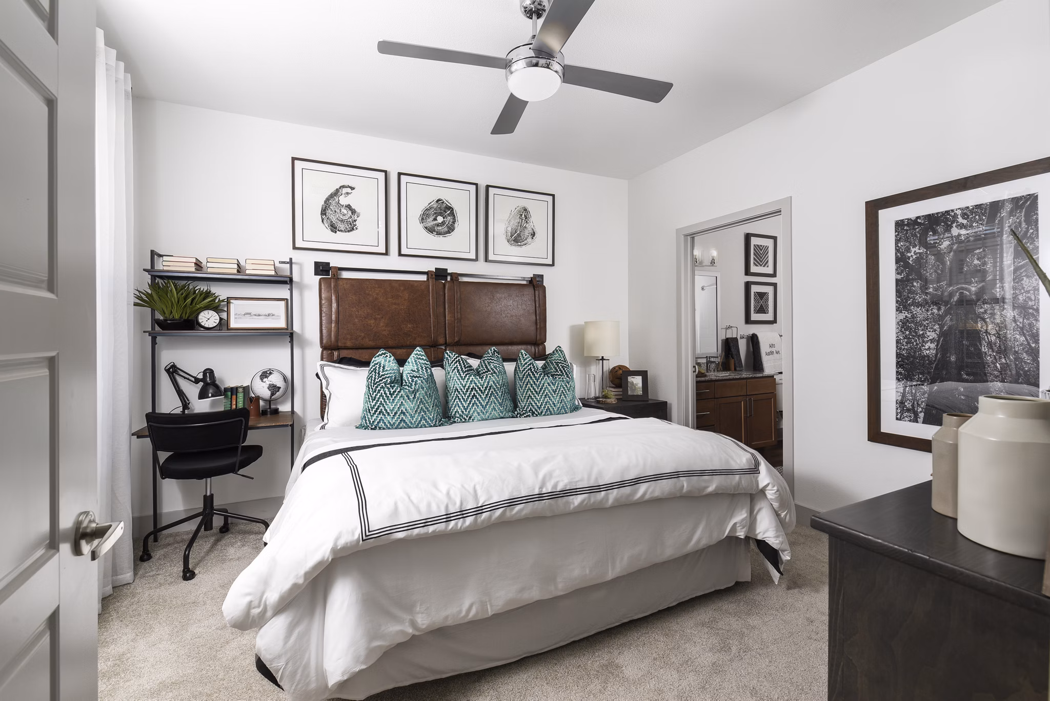Cozy bedroom with modern decor and ample natural light at Austin Avenue Apartments