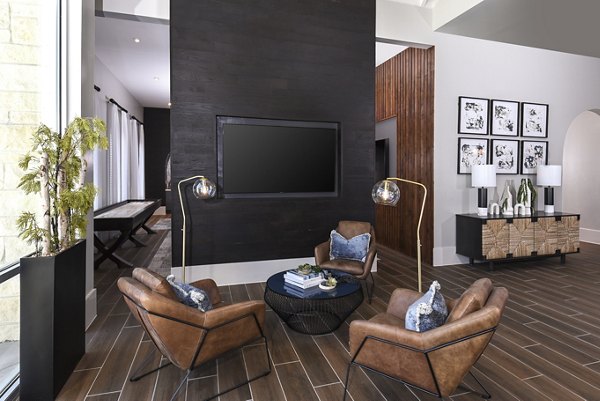 Modern clubhouse with comfortable seating and entertainment options at Austin Avenue Apartments, promoting luxury apartment living