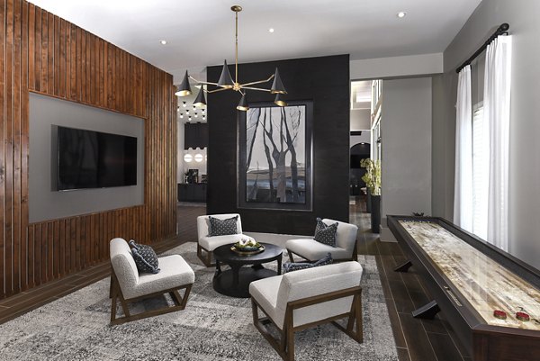 Clubhouse with modern design and entertainment spaces at Austin Avenue Apartments