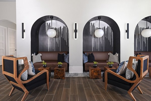 Clubhouse featuring modern furnishings and vibrant decor at Austin Avenue Apartments