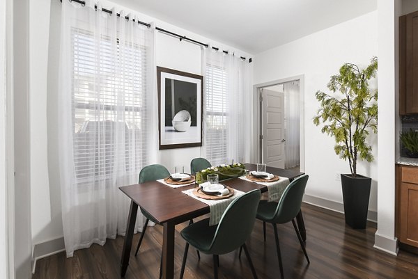 Dining area featuring modern furnishings and contemporary lighting at Austin Avenue Apartments