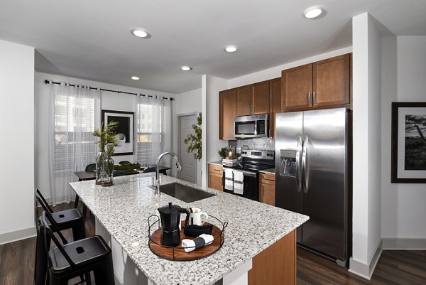 Modern kitchen with stainless steel appliances in Austin Avenue Apartments