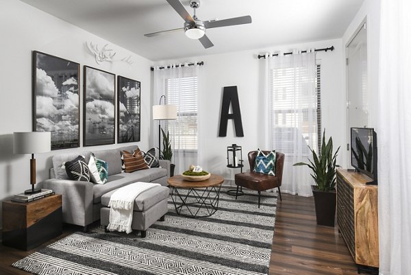 Modern living room with elegant furnishings at Austin Avenue Apartments in a vibrant Greystar community