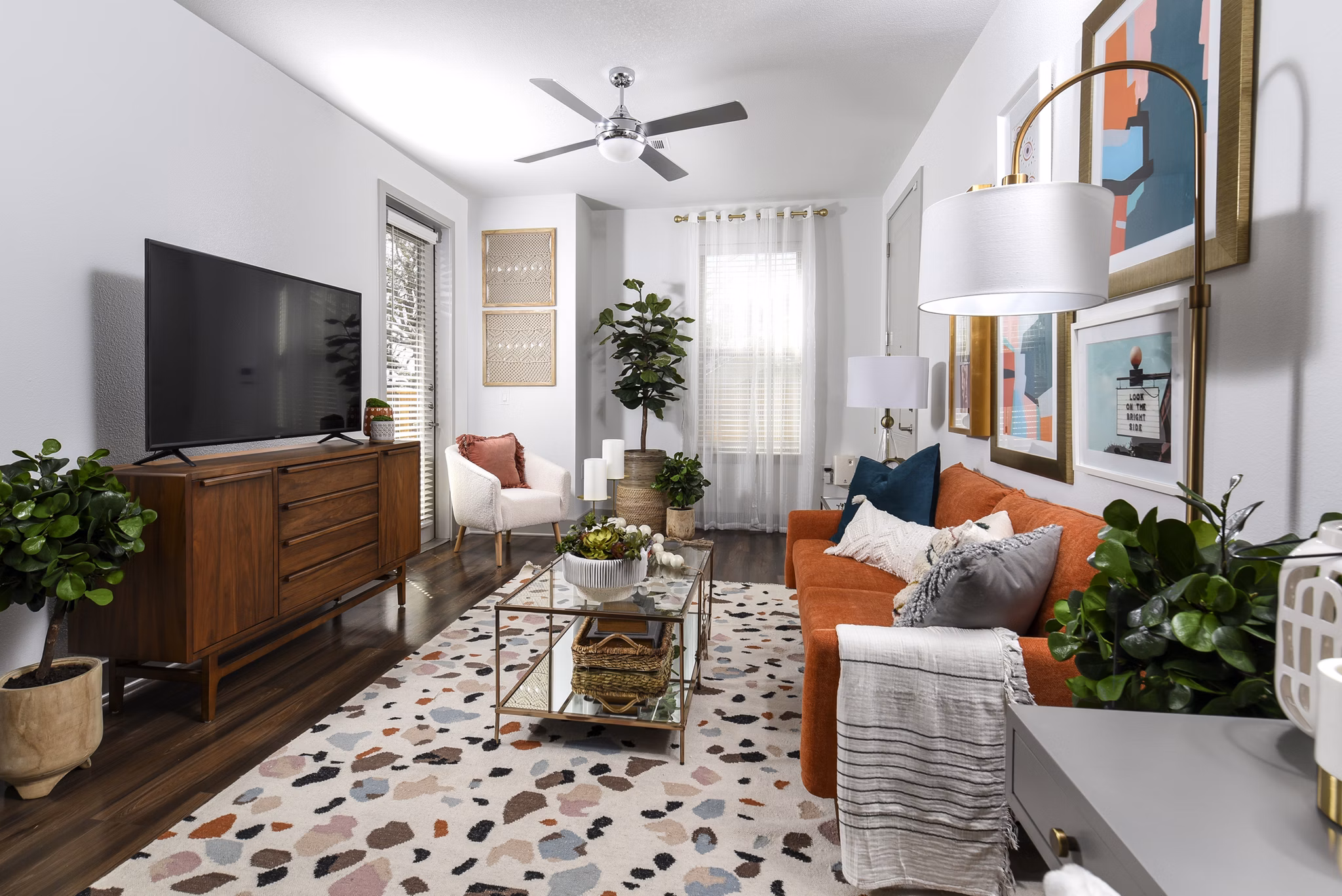 Living room with modern decor and ample natural light at Austin Avenue Apartments