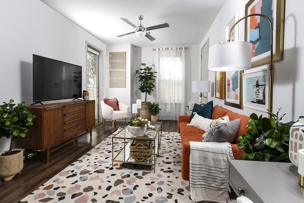 Living room with modern decor and ample natural light at Austin Avenue Apartments