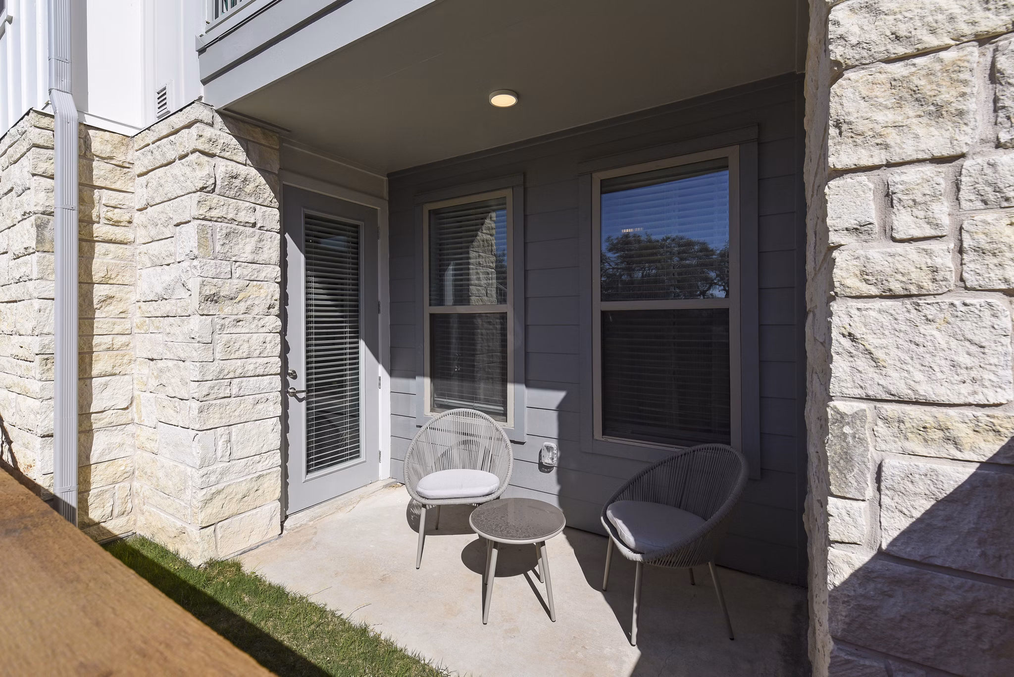 Spacious patio with modern seating at Austin Avenue Apartments, perfect for outdoor relaxation