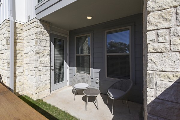 Spacious patio with modern seating at Austin Avenue Apartments, perfect for outdoor relaxation