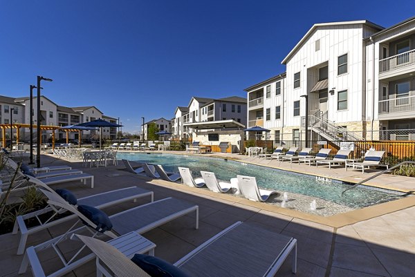 Refreshing outdoor pool at Austin Avenue Apartments offering luxury leisure at Greystar's premier property