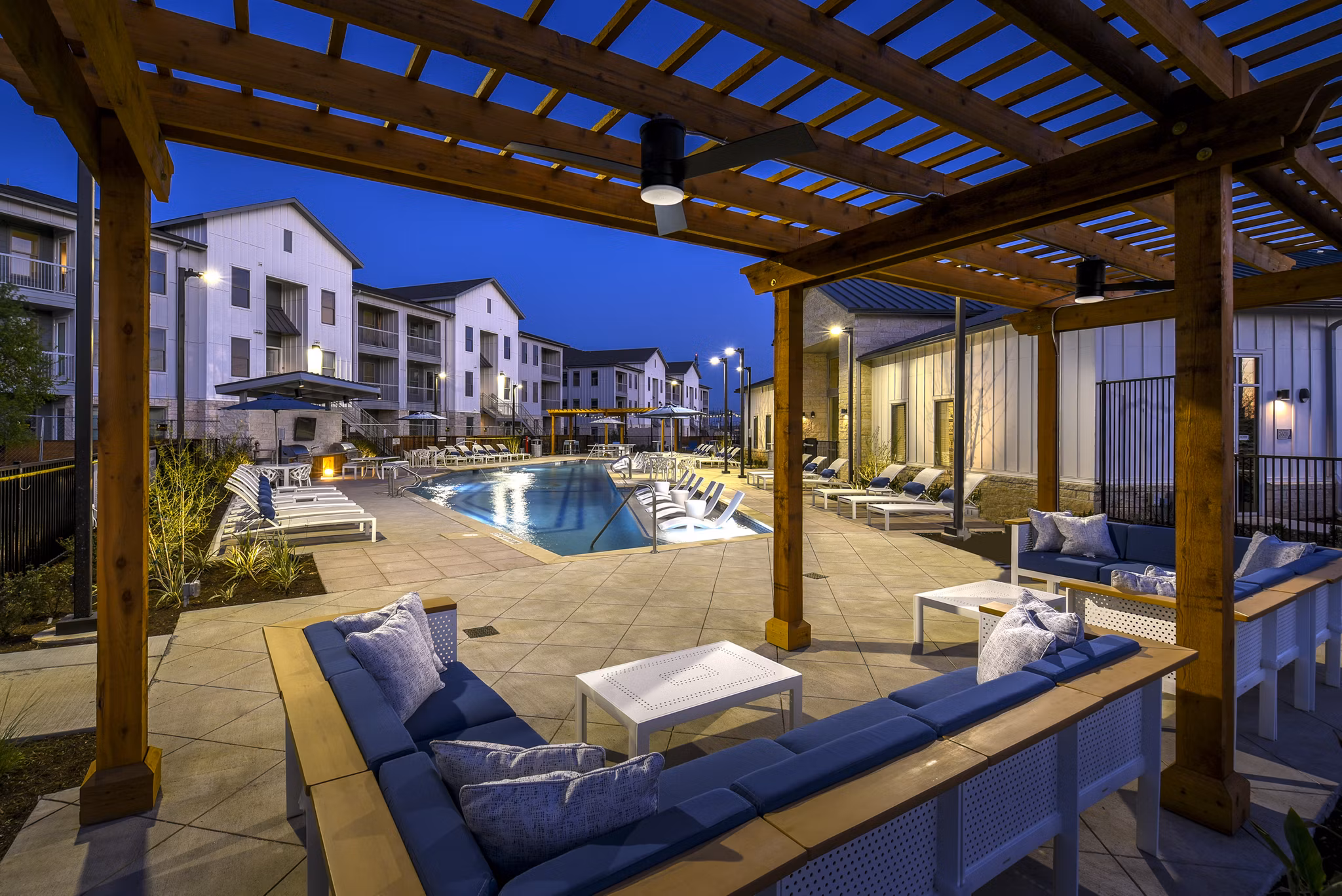 Modern outdoor pool at Austin Avenue Apartments featuring resort-style seating and lush landscaping