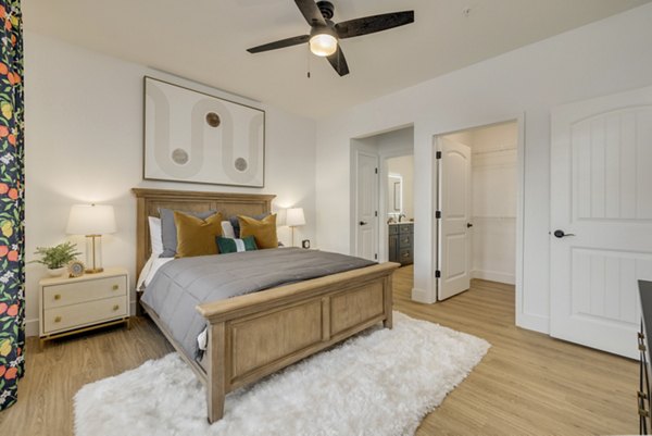 Cozy bedroom with elegant decor at The Banks at Rivergate Apartments, offering luxury living spaces in a serene setting