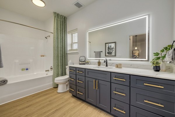 Spacious bathroom with modern fixtures at The Banks at Rivergate Apartments, showcasing luxury living