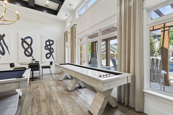 Game room featuring pool tables and arcade games at The Banks at Rivergate Apartments