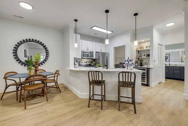 Dining area with modern furnishings and sleek lighting at The Banks at Rivergate Apartments