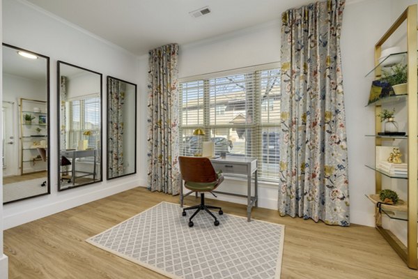 Modern home office with sleek desk and large window in The Banks at Rivergate Apartments