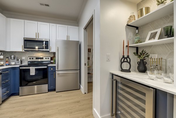 Modern kitchen with stainless steel appliances at The Banks at Rivergate Apartments