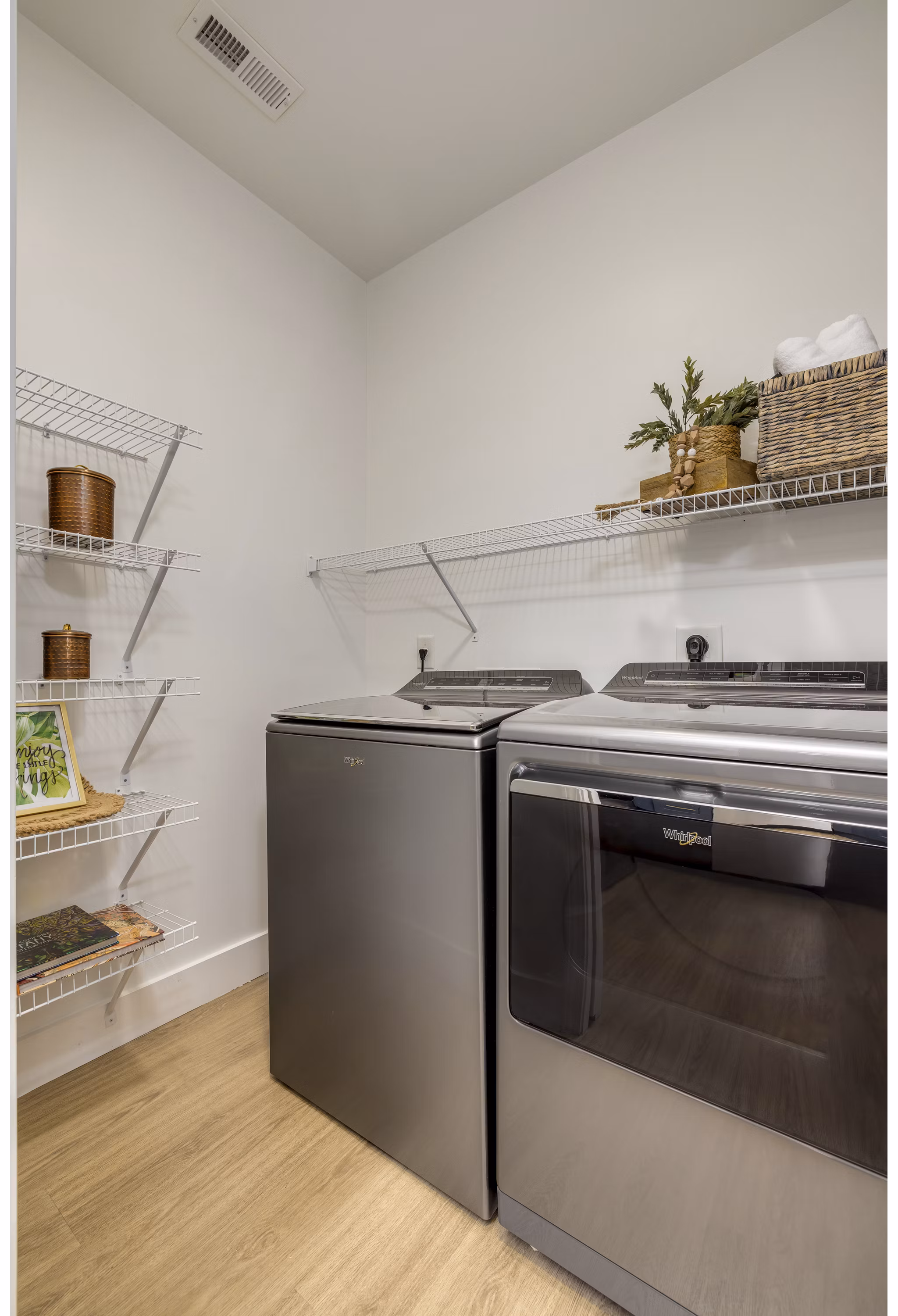 Laundry room featuring modern appliances at The Banks at Rivergate Apartments