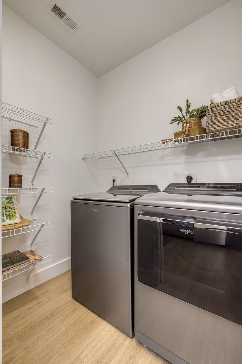 Laundry room featuring modern appliances at The Banks at Rivergate Apartments