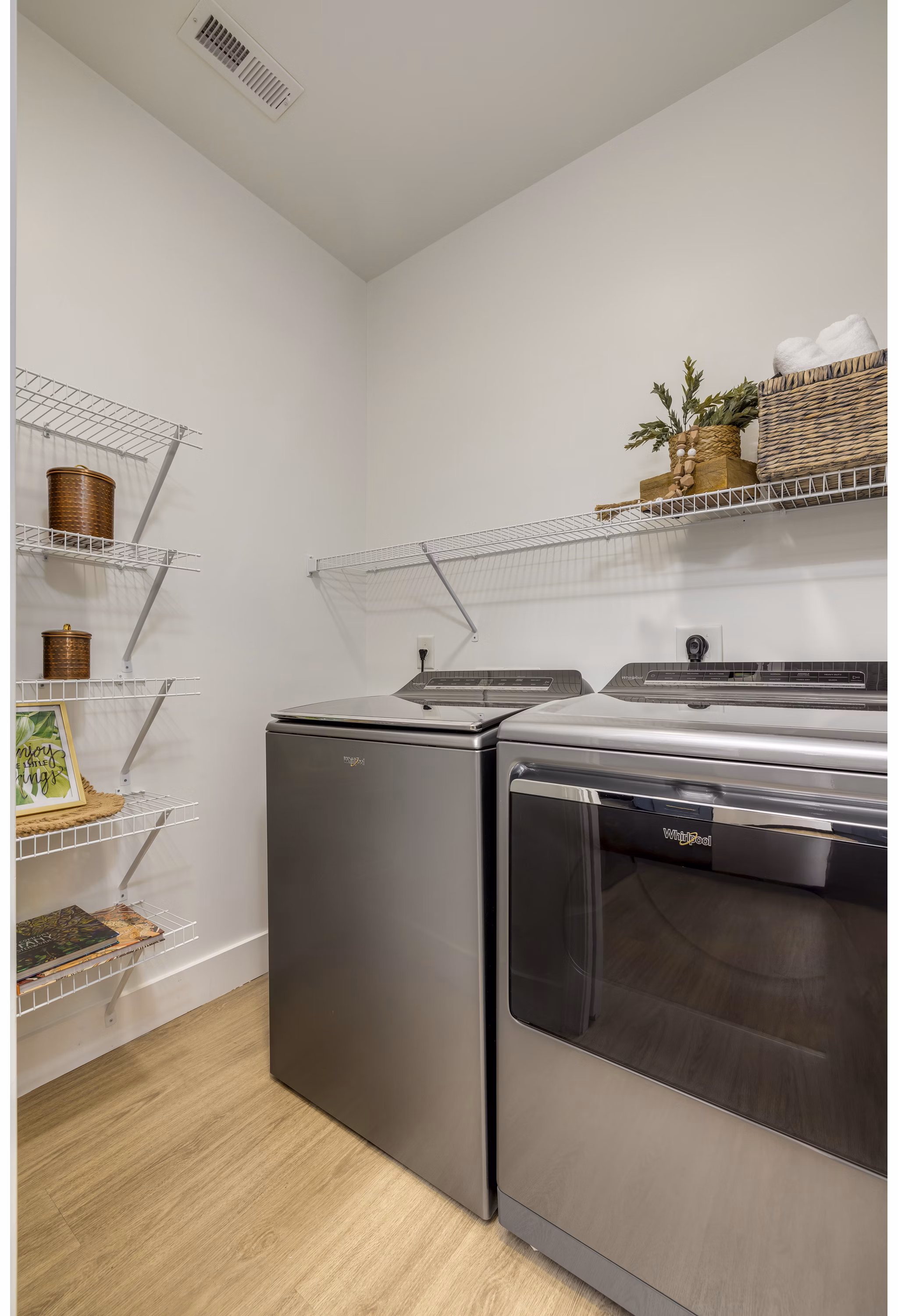 Laundry room featuring modern appliances at The Banks at Rivergate Apartments