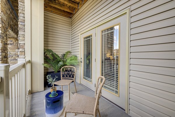 Modern patio area with stylish seating and greenery at The Banks at Rivergate Apartments