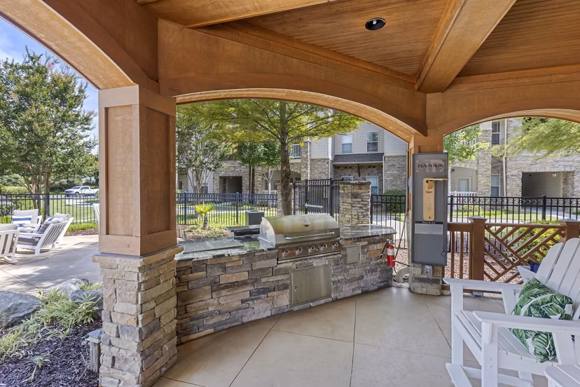 Outdoor grill area with modern seating at The Banks at Rivergate Apartments, offering a luxurious dining experience for residents