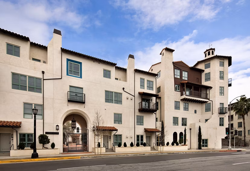 Andalucia Apartments: Elegant facade and lush landscaping at luxury community in Los Angeles